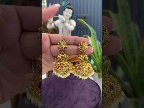 Traditional jumkhas with green beads and Laxmi Devi motive