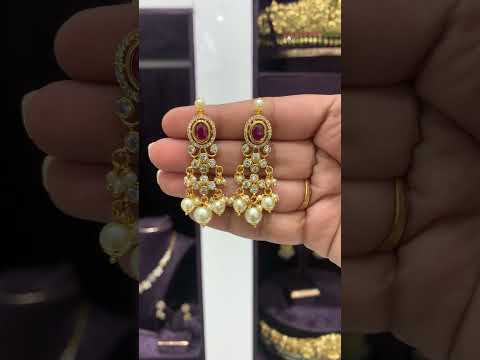 Beautiful earrings with green stone and Pearls hangings