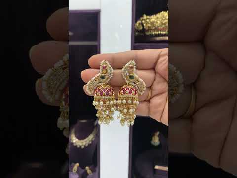 Beautiful jumkhas with green stone and peacock design