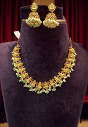 Beautiful short necklace with green stone and Laxmi Devi motive