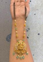 Load image into Gallery viewer, Beautiful black beads chain with green beads and Laxmi Devi motive pendant