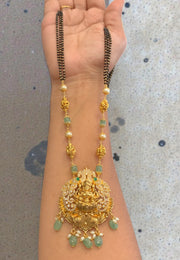 Beautiful black beads chain with green beads and Laxmi Devi motive pendant