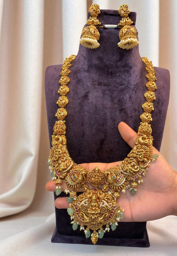 Traditional long nakshi haram with Laxmi Devi motive pendant and green beads