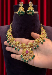 Beautiful short necklace with green beads and pink stone