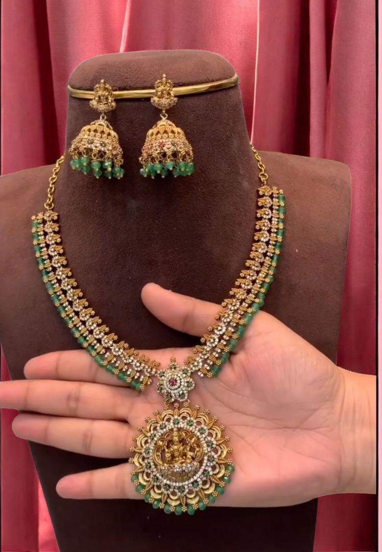Beautiful short haram with gold finishing and green stone hangings