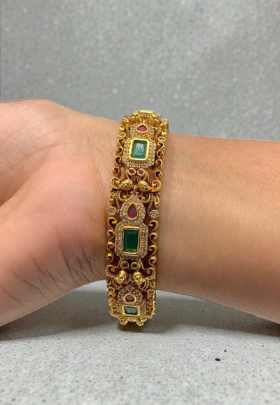 Traditional nakshi bangle with green and pink stone