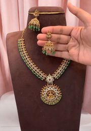 Beautiful short haram with gold finishing and green stone hangings