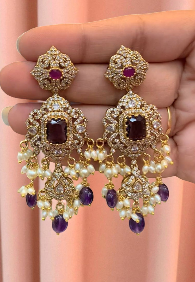 Stunning earrings with purple stone and guttapusalu hangings
