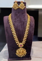 Load image into Gallery viewer, Beautiful nakshi polish long haram with ruby colour stone and God laxmi motive pendant -pairing with beautiful earrings
