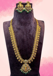 Traditional long haram with green stone and kasulu designed and God laxmi devi motive
