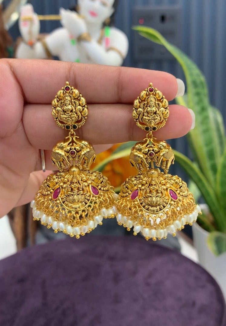 Traditional jumkhas with green beads and Laxmi Devi motive